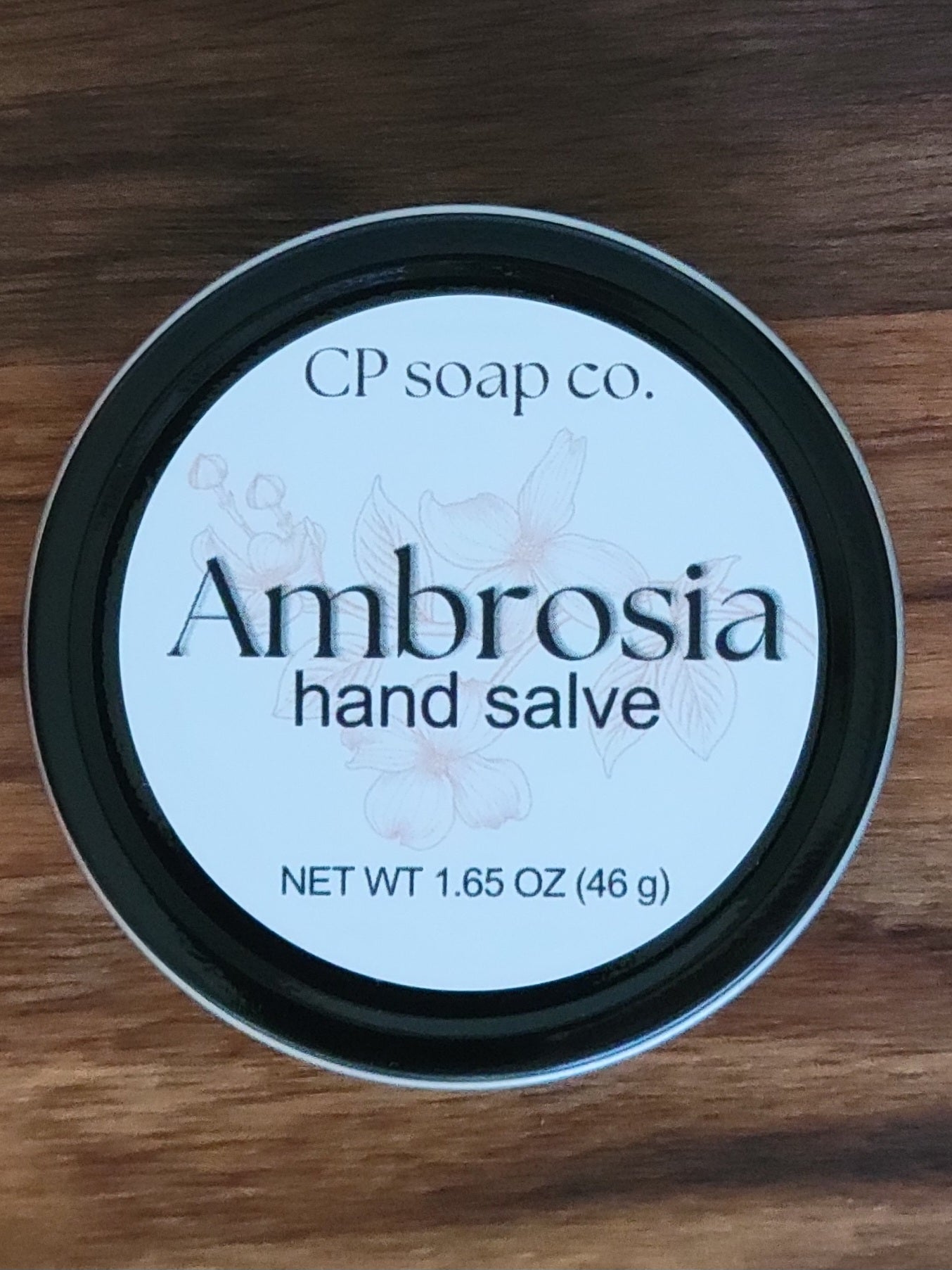 CP Soap Co. Ambrosia hand salve container on a wooden surface