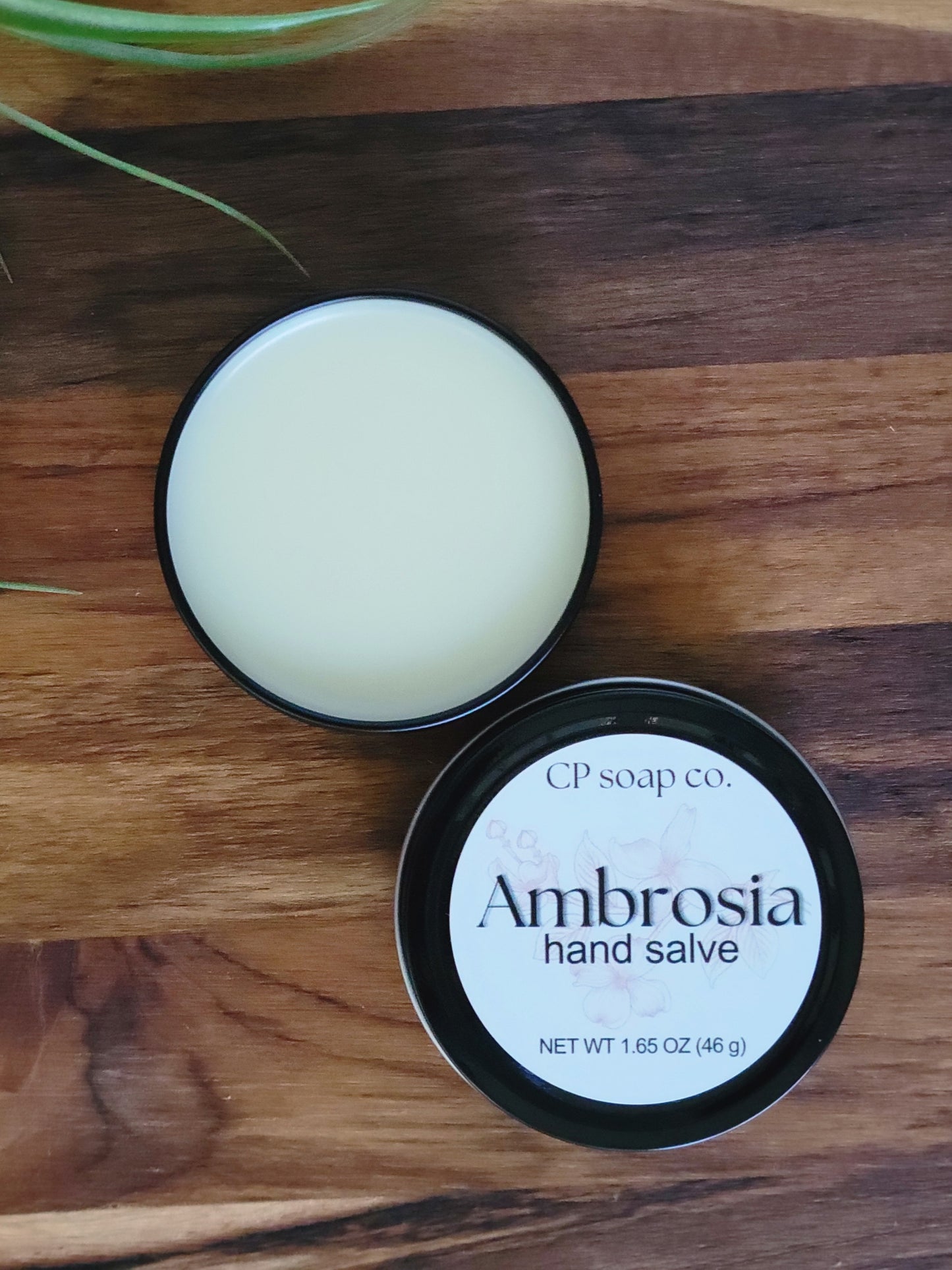 CP Soap Co. Ambrosia hand salve on a wooden surface