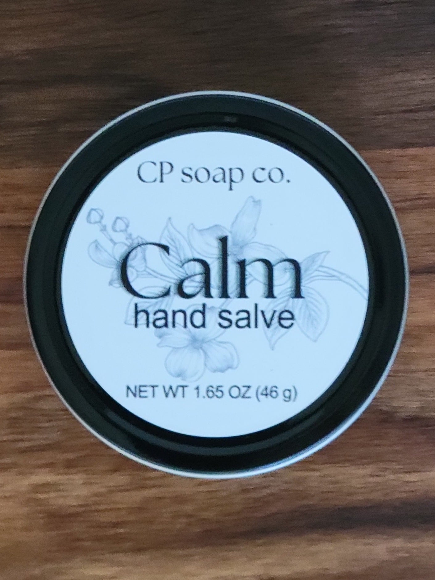 CP Soap Co. Calm hand salve container on a wooden surface
