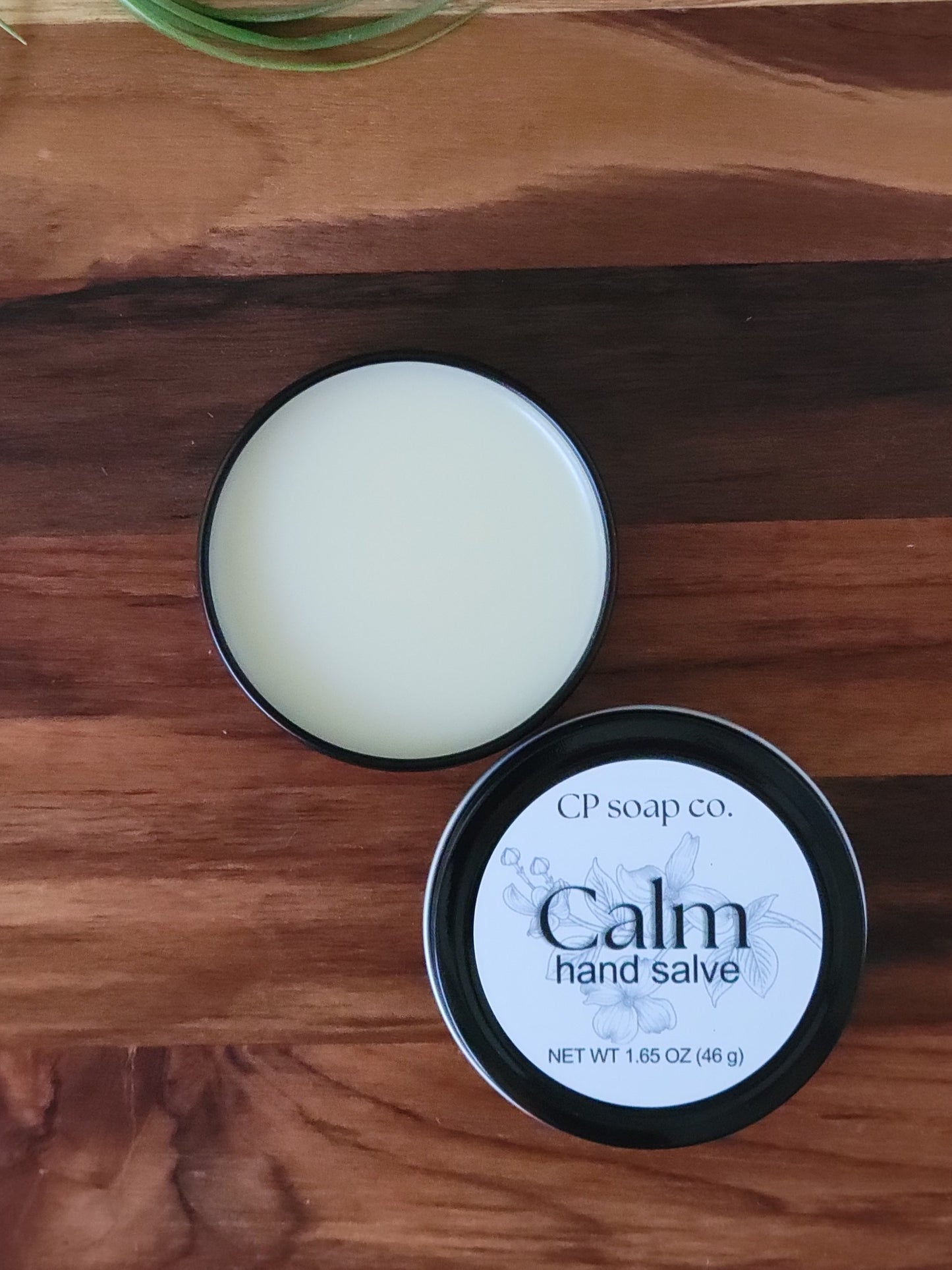 CP Soap Co. Calm hand salve on a wooden surface