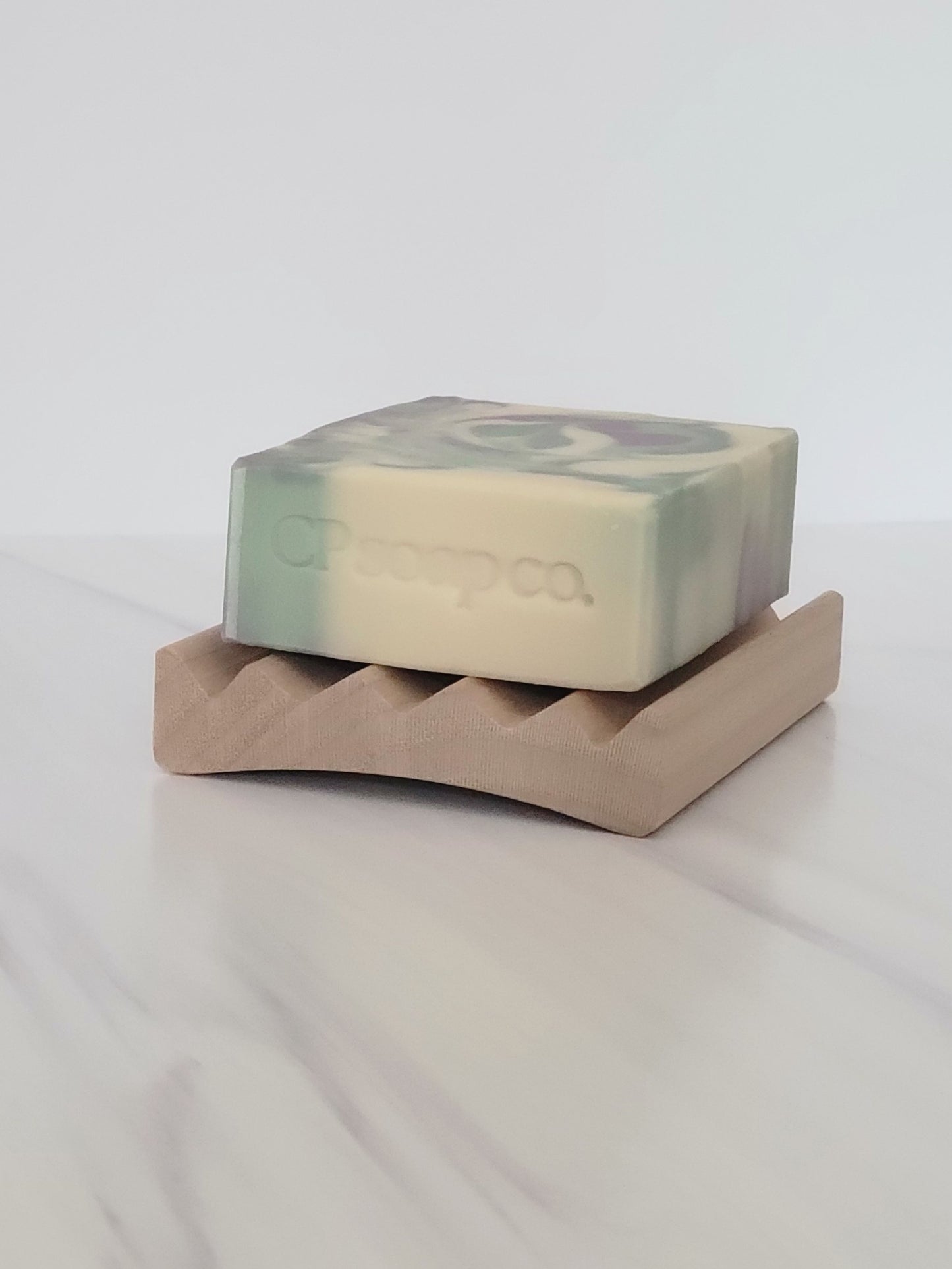 Poplar wood soap dish with the Dream Bar cold process soap showing the curve of the dish