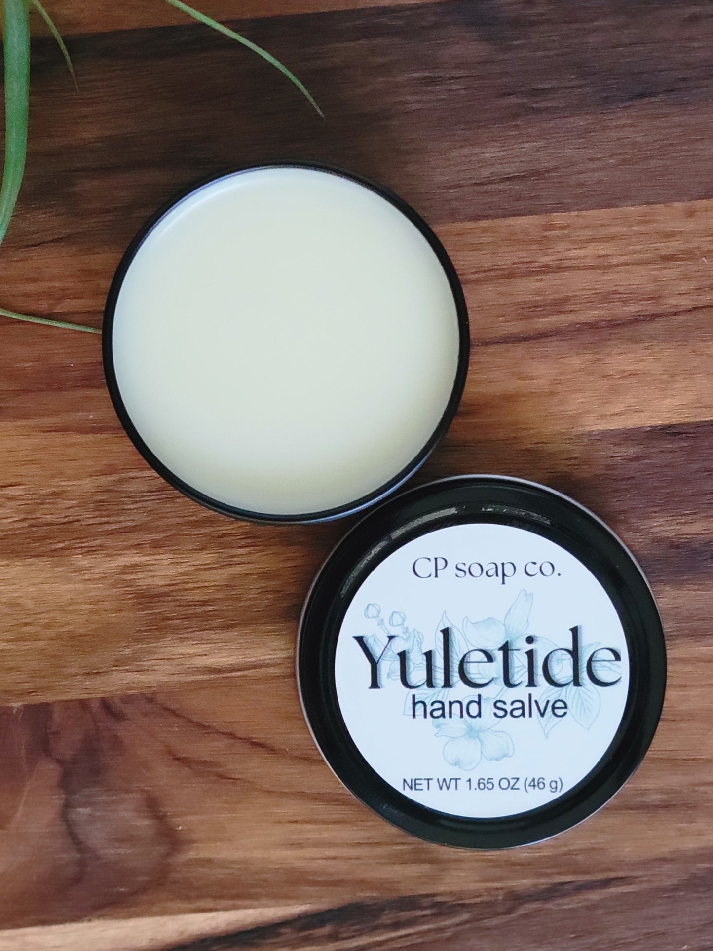 Yuletide hand salve from CP soap co. on a wooden surface