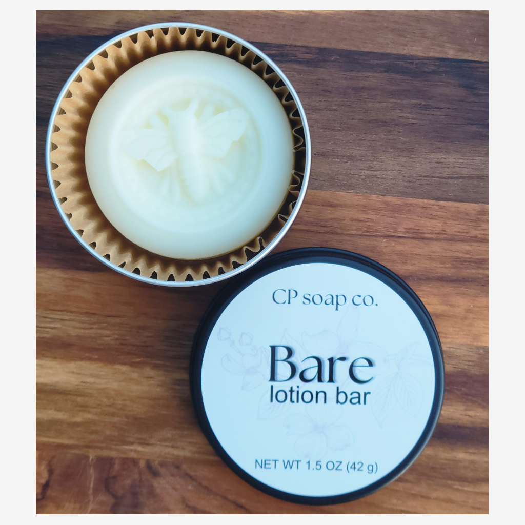 CP Soap Co. Bare lotion bar with packaging on a wooden surface