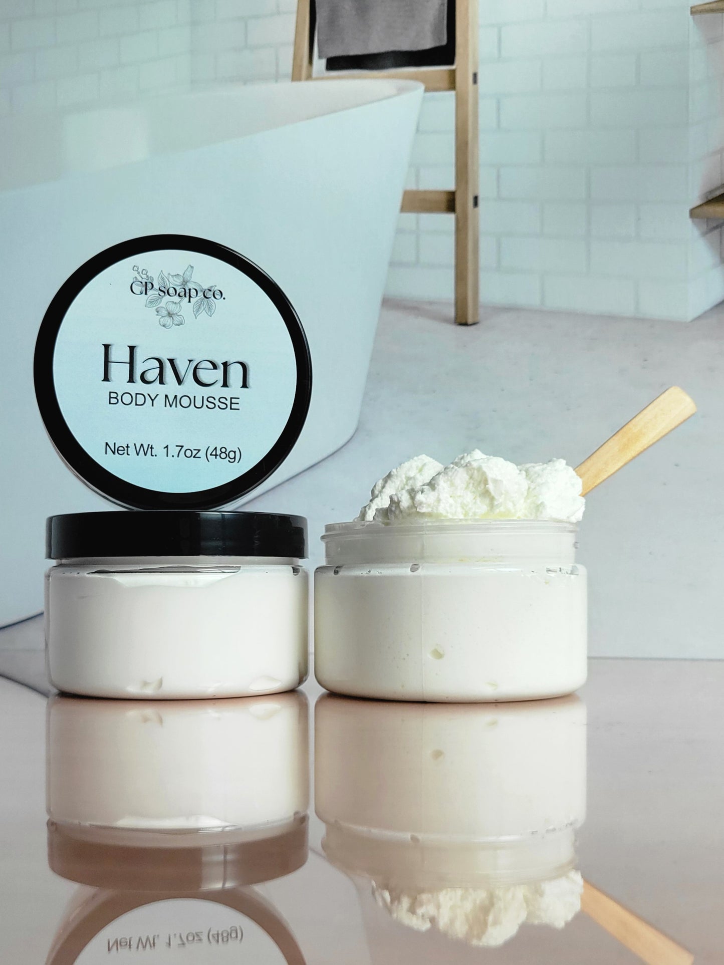 CP Soap Co. Haven Body Mousse jar with whipped cream on a reflective surface