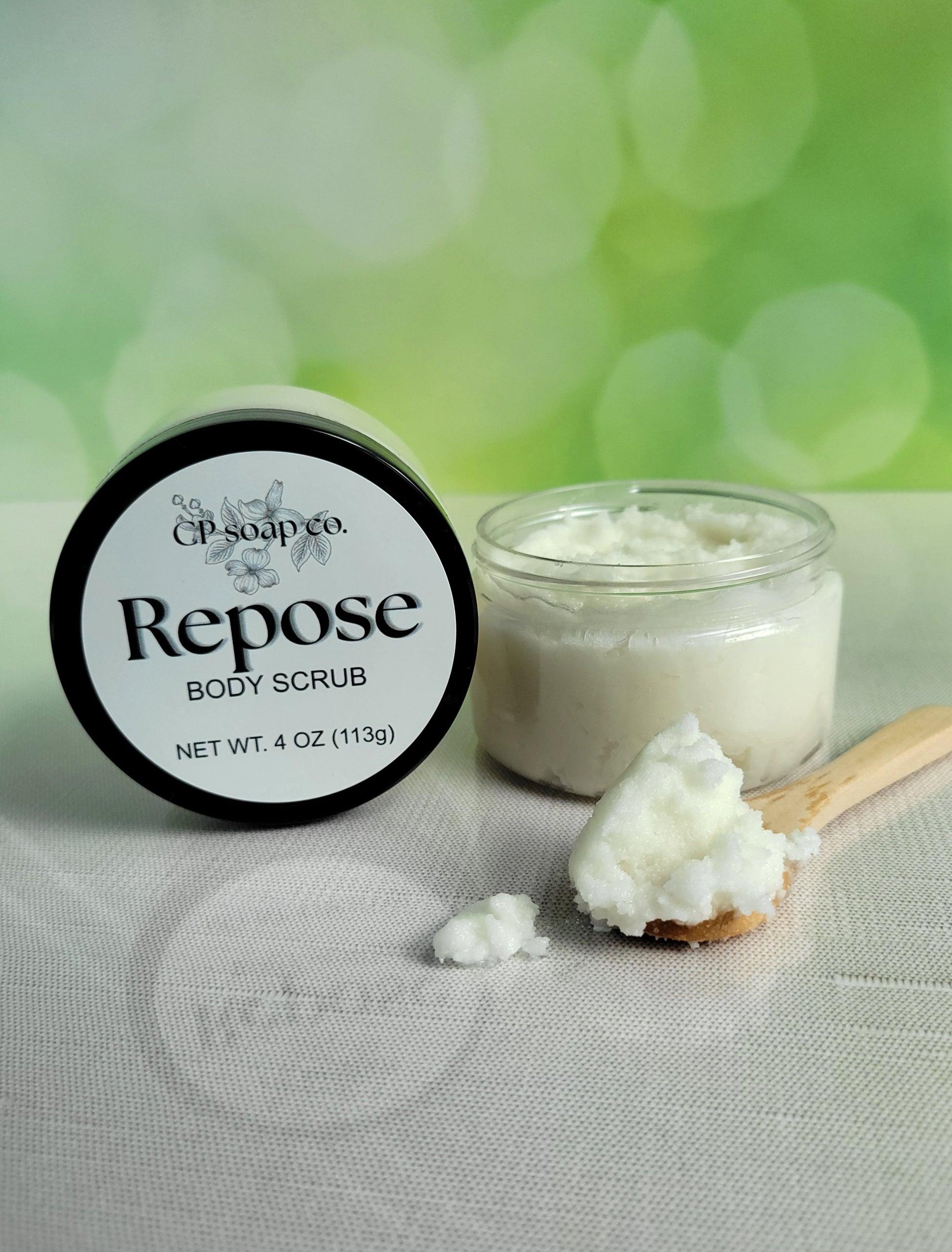 Repose body scrub with a jar and scoop on a light background