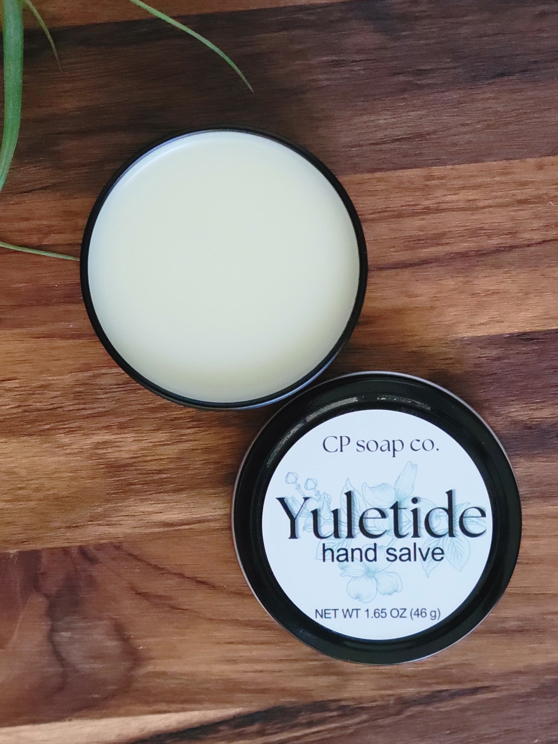 Yuletide hand salve from CP soap co. on a wooden surface